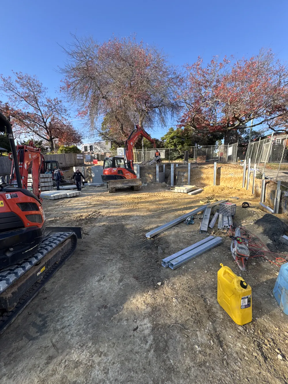 06 – Residential build, red excavator photo 1